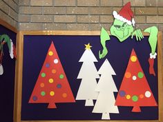 a bulletin board with paper cut out of christmas trees and grino on the top