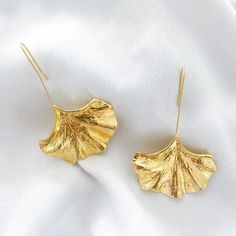 Introduce a touch of uniqueness with our Nicholls Drop Fan Earrings in Gold. The elegant fan-shaped design adds a statement to any outfit - perfect for a night out, holiday, or wedding. Made with nickel, lead, and cadmium-free materials, these drop earrings are both stylish and safe to wear. Approximate Total Drop Length 3.5" Leaf-shaped Metal Earrings For Party, Leaf-shaped Metal Jewelry For Party, Silver Leaf-shaped Earrings For Party, Elegant Metal Wing-shaped Earrings, Elegant Wing-shaped Metal Earrings, Elegant Leaf-shaped Earrings For Party, Elegant Gold Wing-shaped Jewelry, Elegant Wing-shaped Gold Jewelry, Elegant Leaf-shaped Party Earrings