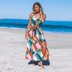 Get ready to turn heads in this stunning belted maxi dress featuring a vibrant abstract print that will take your style game to the next level. The flowy silhouette and cinched waist create a flattering look that is perfect for any occasion. With its vibrant abstract print, flowy silhouette, and cinched waist, this belted maxi dress is a must-have for elevating your style game and making a fashionable statement. Step into any occasion with confidence and show off your impeccable sense of style. Multicolor Print Maxi Dress For Vacation, Multicolor Midi Maxi Dress For Vacation, Bohemian Belted Maxi Dress For Vacation, Multicolor Midi Beachwear Maxi Dress, Chic Multicolor Belted Maxi Dress, Green Belted Beach Dress, Summer Maxi Dress With Tie Waist, Beach Season Maxi Dress With Tie Waist, Chic Belted Maxi Dress For Vacation