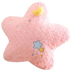 a pink star shaped plush toy with stars on it's side and a yellow nose