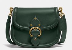 This COACH C0749 Beat Leather Saddle Crossbody Bag in Amazon Green is the perfect accessory for any woman on-the-go. Crafted from high-quality leather, it features a magnetic flap and snap closure, as well as a detachable and adjustable strap for added convenience. The bag measures 8.75\"L x 7\"H x 2.25\"D and has a 21.5\" drop strap. The bag also boasts a beautiful red sand exterior with brass gold hardware accents, including a buckle. The interior lining is also leather, adding to the bag's lu Saddle Crossbody Bag, Red Sand, Brass Gold, High Quality Leather, Crossbody Shoulder Bag, Saddle Bags, Gold Hardware, Snap Closure, Saddle