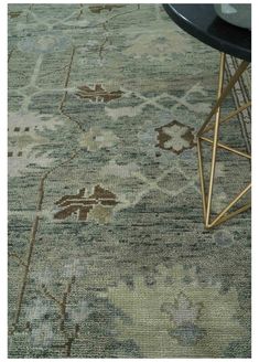 an area rug with various designs and colors on the floor, including a blue chair