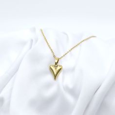 Wear your heart on your neck with our Puffy Heart Necklace! Perfect for lovers (even if it's just self-love). This playful necklace adds a touch of whimsy to any outfit. Gold Plated Stainless Steel 15.75" Chain With 2.75" Extender Jewelry Care: It is important to gently clean your jewelry with a soft cloth after each use. We recommend removing your jewelry when bathing or before applying oils, lotions, and perfumes for optimal longevity. Heart Charm Pendant Necklace For Valentine's Day, Everyday Heart Charm Necklaces For Mother's Day, Everyday Heart Charm Necklace For Mother's Day, Heart Detail Necklace For Everyday Valentine's Day, Heart Shaped Necklace For Mother's Day, Heart-shaped Charm Necklace For Valentine's Day, Heart Necklace For Everyday Valentine's Day, Everyday Heart Detail Necklace For Valentine's Day, Everyday Double Heart Necklace For Valentine's Day