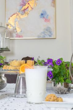 the table is covered with flowers, cookies and other items that are sitting on it