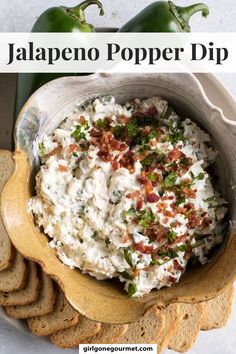 jalapeno popper dip in a bowl with crackers on the side