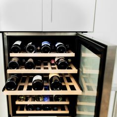 a wine cooler with many bottles in it