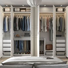 an open closet with clothes hanging on the walls, and a bed in front of it