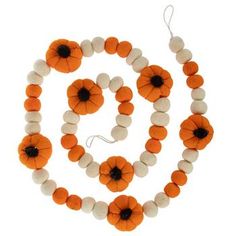 an orange and white necklace with black beads