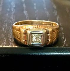 A 14kt yellow gold antique old European cut diamond ring.  Size 7 1/8. Diamond bead set in white gold.   Condition is good for its age-wear commensurate with age.  THE DIAMOND is an old EUROPEAN or miner cut diamond-the diamond faceting is good there is a bit of a typical inclusion(carbon)-not noticeable when worn only mentioned for accuracy.  It has a Deco styled shank with some wear from age but -smooth wear commensurate with its age.  Circa first half of the 1900s.  Easy statement ring to wea Vintage Signet Ring With Brilliant Cut, Classic Collectible Rings With Diamond Accents, Classic Rings With Diamond Accents For Collectors, Vintage Yellow Gold Diamond Ring For Formal Occasions, Collectible Gold Diamond Ring With Brilliant Cut, Collectible Yellow Gold Diamond Ring With Round Cut, Antique Oval Single Diamond Ring, Antique Oval Diamond Ring With Single Diamond, Antique Gold Diamond Ring With Rose Cut Diamonds