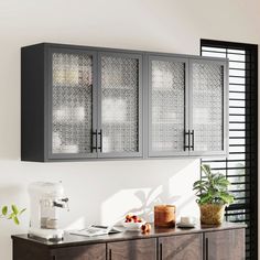 a cabinet with glass doors is in the middle of a room next to a potted plant