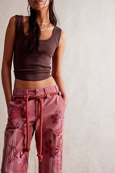 So unique from our We The Free collection, these embroidered pants add an elevated touch to every outfit. **Fit:** Low-rise, cropped length **Features:** Zip-fly and button closure, adjustable belt at waistband, embroidered floral detailing, welt pockets at back, cuffed legs **Why We ❤ It:** These one-of-a-kind pants are the perfect pair for any warm weather occasion. | We The Free Electric Sands Embroidered Pants at Free People in Brown, Size: US 6 Vintage Runway Fashion, Embroidered Trousers, Vintage Runway, Embroidered Pants, Free People Style, All Jeans, Boho Casual, Adjustable Belt, Casual Street Style