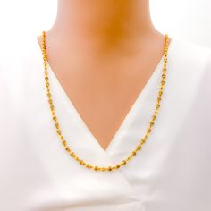 This luxurious necklace is skillfully crafted with 22k gold, totaling 11.8 grams, with 11.0 grams in gold and 0.8 grams in Tulsi beads. It showcases a radiant yellow gold finish and measures 26 inches in length, seamlessly designed without a lock for uninterrupted elegance. The subtle inclusion of Tulsi beads adds a touch of spiritual significance, making this piece not only a fashion statement but also a nod to cultural heritage. Ideal for those seeking jewelry that blends sophistication with m Gold Plated Temple Necklace With Tilla, Gold Plated Yellow Gold Temple Necklace With Tilla, Yellow Gold Temple Necklace With Tilla, Gold Plated, Yellow Gold Temple Necklace With Tilla Detailing, Gold Necklaces With Tilla Detailing In 22k Gold, 22k Gold Necklaces With Tilla Detailing, 22k Gold Necklace With Tilla, Gold Necklaces With Tilla Detailing, 22k Gold Temple Necklace With Gold Beads