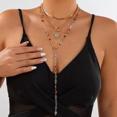 This stunning Regina Layered Lariat Necklace Set brings a playful yet elegant touch to any ensemble. Featuring a multi-color beaded design, this layered necklace set is perfect for adding a splash of color to your outfits. The lariat drop design adds a chic and sophisticated look, making it ideal for both casual wear and special occasions. The set includes two necklaces, each offering a different length for an effortlessly layered appearance. Details: Material: Gold-plated brass with colorful beads Set weight: 42.4g (1.49oz) Short necklace length: 37cm + 7cm extension (14.5in + 2.7in) Long necklace length: 70cm (27.5in) Pendant size: 2.5cm x 0.98in Chain thickness: 0.6cm (0.23in) Eye-catching multi-color bead accents Layered lariat drop design for a trendy and unique look Missy Jewelry Nec Bohemian Lariat Necklace With Clavicle Chain For Parties, Rainbow Beaded Necklace For Party, Multicolor Lariat Long Necklace For Gifts, Elegant Multicolor Adjustable Chain Necklace, Trendy Adjustable Lariat Layered Necklace, Bohemian Lariat Necklace With Dangle For Party, Adjustable Multicolor Lariat Long Necklace, Adjustable Multicolor Long Lariat Necklace, Bohemian Lariat Choker Necklace For Party