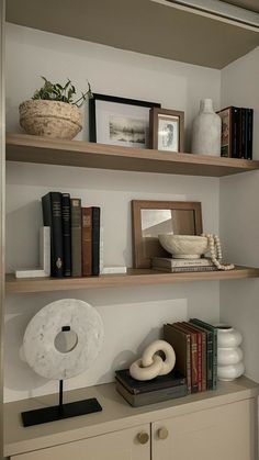 some shelves with books and pictures on them