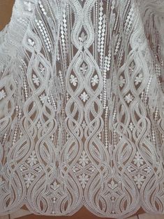 the white lace is hanging on the wall