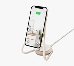 an iphone with a charging station attached to it's back side, on a white background