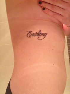 a woman's stomach with the word everything written in cursive writing on it