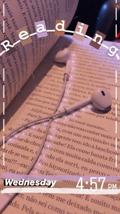 an open book with headphones on top of it and the words reading wednesday written in white