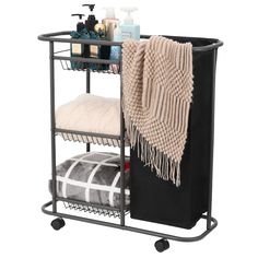 a black rolling cart with towels and other items on it