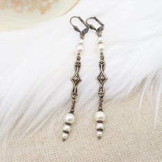 These earrings were handmade by me in the Art Deco style but with new (made to look old) components!  They would be great for your roaring 20's party - they are light and comfortable and stylish!  The earrings feature cream pearls - they are crystal cored high quality faux pearls, in various sizes, attached to unique art deco style brass metal connectors.  The connectors are hollow on the back.  The earrings end with brass lever back ear wires.  Total length is 3.25 inches with just 1/4 inch wid Roaring 1920s, Pearl Art, Deco Earrings, Flapper Style, Pearl Cream, Classy Jewelry, Black Tie Event, Art Deco Earrings, Jewelry Women