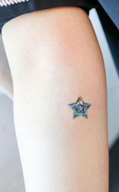 a woman's arm with a small star tattoo on the left side of her leg