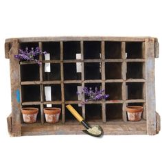 an old wooden shelf with pots and flowers in it on top of a white background