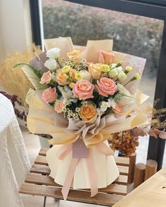 a bouquet of flowers sitting on top of a wooden table