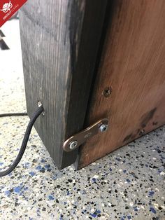 a close up of a wooden door with a cord attached to the front and side