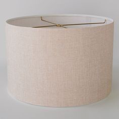 a beige lampshade with a white drum light shade