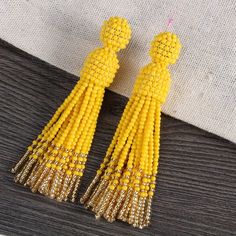 Champagne Gold Bead Tassel Earring -oscar de la renta tassel earrings Yellow Tassel Earrings As Gift, Party Tassel Earrings With Round Beads, Beaded Tassel Earrings With Round Beads For Parties, Adjustable Tassel Earrings With Colorful Beads For Party, Yellow Dangle Tassel Earrings For Party, Yellow Dangling Beads Earrings For Party, Elegant Yellow Tassel Earrings, Yellow Tassel Drop Earrings With Dangling Beads, Yellow Beaded Tassel Earrings As Gift