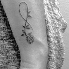 a woman's arm with a tattoo on it and a rose in the middle