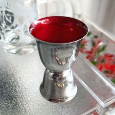 a silver cup sitting on top of a table