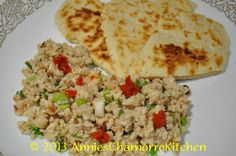 the meal is prepared and ready to be eaten on the plate, including pita bread