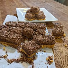 several pieces of dessert sitting on top of a wooden table