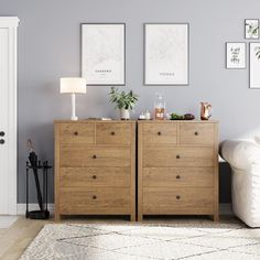 a living room scene with focus on the chest of drawers and pictures hanging above it