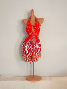 a mannequin dressed in red and silver sequins