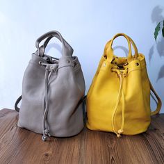 The charming Convertible Leather Bucket Bag is the perfect combination of elegance and practicality. Crafted from high-quality leather, this model offers a convenient conversion from a classic bag to a comfortable backpack. Its unique design allows for easy shape-shifting, providing style and functionality for any occasion. The yellow pouch and beige pouch bag is from soft genuine leather. Backpacks are crossbody and leather totes for women's. Beige backpack is work backpack and messenger purse. Leather Bucket Satchel For On-the-go, Daily Use Beige Leather Bucket Bag, Everyday Leather Mobile Phone Bag, Versatile Beige Leather Bucket Bag, Versatile Bucket Bag With Phone Pocket For Daily Use, Leather Crossbody Bucket Bag With Phone Bag, Leather Satchel Hobo Bag With Mobile Phone Bag, Leather Hobo Bag With Mobile Phone Bag, Everyday Bucket Satchel With Mobile Phone Bag