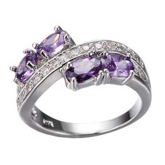 a ring with purple stones and diamonds on the sides, set in white gold plated silver