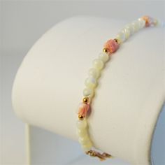 Coral Tulip Bracelet Elegant Coral & Mother Of Pearl Beads, 7”, And Gemstones Set In Yellow Gold Filled. White Polished Beads Bracelets As Gift, Adjustable Single Strand White Bracelet, White Single Strand Beaded Bracelet For Gift, White Single Strand Bracelet Gift, White Single Strand Bracelet As A Gift, Elegant White Bracelet With Colorful Beads, Adjustable White Bracelet With Polished Beads, Elegant White Pearl Bracelet With Faceted Beads, Adjustable White Bracelets With Polished Beads