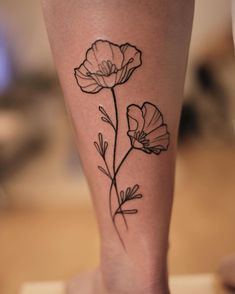 a woman's leg with a flower tattoo on it