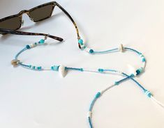 Miyuki Beaded Glasses Chain,Real Seashell Sunglasses Strap, Eye Glass Holder,Boho Hippie Mask Chain,Summer Jewelry,Beach Seed Beads Lanyards If you are tired of playing hide and seek with your glasses and masks, there is a colorful news for you! Thanks to our handmade eyeglass straps, which make it almost impossible to lose glasses and give life to boring frames, you can wear your glasses comfortably by hanging them on your neck when not wearing them. It completes your full BOHO chic look! You c Handmade Beach Necklace For Summer, Beach Season Jewelry With Beaded Chain, Handmade White Glasses Chains For Festival, Handmade White Glasses Chains For Summer, Adjustable Turquoise Beaded Necklace For Beach, Summer Beaded Shell Necklaces, Blue Beaded Necklaces For Beach In Summer, Summer Glass Beaded Chain Necklace, Trendy Beaded Chain Jewelry For The Beach