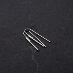 Elevate your style with these Handmade Sterling Silver Threader Earrings. Crafted with precision, these minimalist earrings feature two sterling silver wires--one at 1.5mm thickness soldered to another at 1mm. The sleek, modern design elegantly threads through your earlobe, creating a striking yet simple statement piece that measures 40mm in height. Choose between a subtle matte finish for a soft, understated look or a polished shiny finish for added brilliance. Whether you're dressing up for a Minimalist Dangle Linear Earrings, Minimalist Silver Linear Earrings For Pierced Ears, Minimalist Hypoallergenic Long Drop Threader Earrings, Minimalist White Gold Earrings With Ear Wire, Modern Silver Threader Earrings With Ear Wire, Modern Silver Long Drop Threader Earrings, Minimalist Everyday Earrings With Lever Back, Minimalist Silver Linear Earrings For Everyday, Minimalist Long Drop Linear Earrings For Pierced Ears