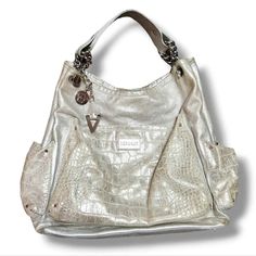 Versace Chain Shoulder Bag Silver Metallic Croc Patterned Leather Large Size  100% Authentic Versace Chain Purse In very good pre-owned condition, please see pictures for normal wear / marks. Buttery Soft Leather Chain / Rivet Detail on the Handle Medusa Grommet & Classic Versace V Grommet Croc Leather On the pockets Sparkly Silver Metallic Leather Y2K style shoulder bag Authenticated through Mercari Larger Sized Shoulder Bag Purse  Measurements (flat lay) Hight: 15" Width: 15" Across the bottom: 4.5" Strap drop: 8" **Fast shipping! Versace Bag Aesthetic, Versace Chain, Versace Bag, Chain Purse, Bag Silver, Versace Bags, Croc Leather, Bags Aesthetic, Y2k Style