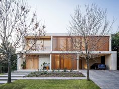 the house is surrounded by grass and trees