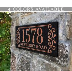 the address plaque is mounted on a stone wall