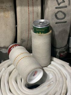 several white hoses and cans sitting next to each other