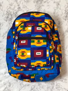 With bold colors and patterns these book bags will be the talk of the town. -Each bag has four pockets to hold all supplies needed for the day. -Adjustable straps-17 inches tall Need something a little smaller, check out our Small Ankara Book Bags. Blue Rectangular Bag With Multiple Pockets, Square Travel Backpack For Back To School, Square Backpack For Travel And Back To School, Multicolor Rectangular Bag For Back To School, Multicolor Rectangular Bags For Back To School, Multicolor Shoulder Bag For School, Multicolor Laptop Bags For Back To School, Multicolor Bags For Daily Use And Back To School, Retro School Bags With Pockets