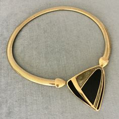 "You are looking at a truly exquisite VINTAGE TRIFARI MODERNIST, ART DECO STYLE, KUNIO MATSUMOTO ERA, BLACK and SILVER-COLOURED ENAMEL AND GOLD METAL OMEGA SNAKE CHAIN PENDANT COLLAR NECKLACE, SIGNED, Circa 1980's. THIS COLLAR NECKLACE IS EXTREMELY BOLD, EYE-CATCHING AND GORGEOUS SUPER RARE MINT, IN EXCELLENT, LIKE NEW CONDITION, IT HAS NEVER BEEN USED THIS NECKLACE WITH AN ART DECO INSPIRED BLACK AND SILVER ENAMEL STATION AND SUPER SHINY OMEGA CHAIN IS EXTRAORDINARILY BEAUTIFUL AND SCULPTURAL T Elegant Evening Necklaces With Black Enamel, Elegant Black Enamel Necklaces For Evening, Elegant Evening Necklace With Black Enamel, Elegant Evening Black Enamel Necklaces, Modern Gold Necklace With Black Enamel, Gold Necklace With Black Enamel For Formal Occasions, Vintage Black Enamel Necklace For Evening, Vintage Black Enamel Necklaces For Evening, Vintage Black Enamel Necklace For Formal Occasions