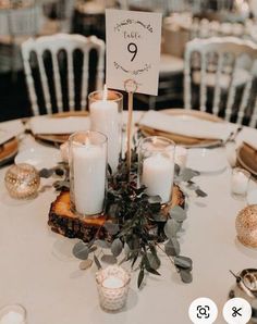 the table is set with candles and place cards