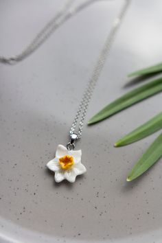 Introducing our Daffodil Bloom Necklace, a captivating floral accessory crafted to elevate your spring style with elegance and charm. Perfect for any occasion, this dazzling pendant captures the beauty of daffodils in full bloom, making it an ideal gift for yourself or a loved one. Add a touch of springtime glam to any outfit and embrace the enchanting allure of this white floral pendant. CHAIN  1) GOLD - High quality 18K gold plated copper metal chain, minimum length - 44cm (17.3 in), max - 50c Spring White Birth Flower Jewelry, Spring Birth Flower Jewelry, Delicate Spring Jewelry Gift, Delicate Spring Jewelry For Gift, Dainty Necklace For Spring Gift, Dainty Necklaces For Spring Gifts, Spring Flower-shaped Jewelry Gift, Silver Necklace For Spring Gift, Spring Gift Silver Necklace